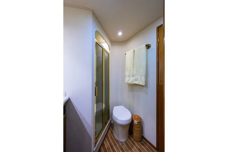 Slide: The Image of Bathroom interior of 2004 Viking 48 Convertible yacht, featuring shower and toilet. - 52