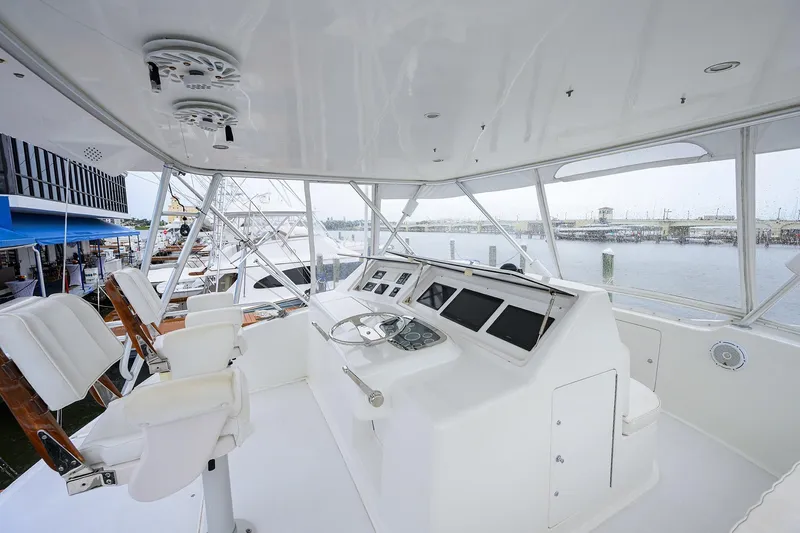 Slide: The Image of Helm of 2004 Viking 48 Convertible yacht with modern controls and seating. - 53