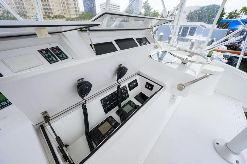 Slide: The Image of 2004 Viking 48 Convertible yacht helm with navigation controls and communication equipment. - 58