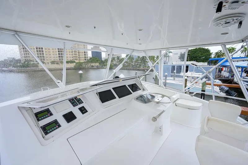 Slide: The Image of 2004 Viking 48 Convertible yacht helm with modern controls and waterfront view. - 59