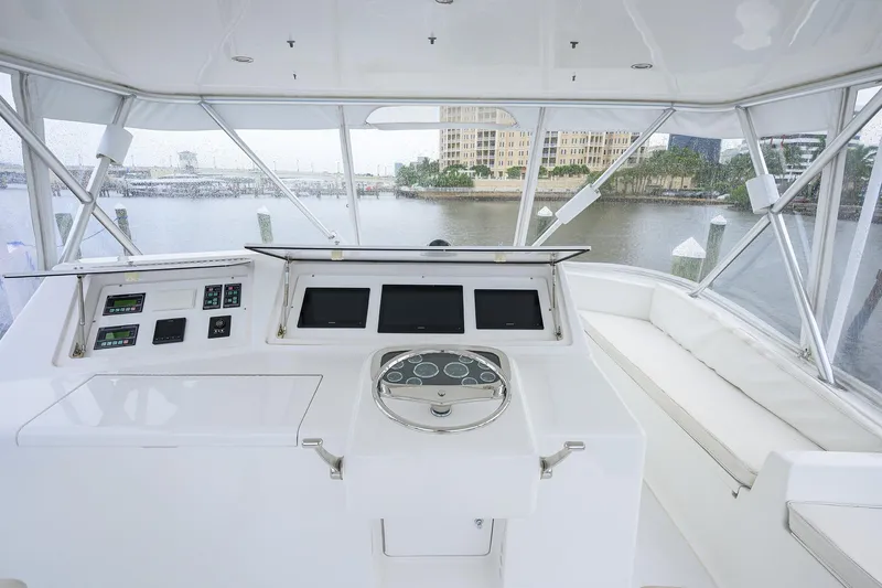 Slide: The Image of 2004 Viking 48 Convertible yacht helm with modern controls and panoramic marina view. - 60