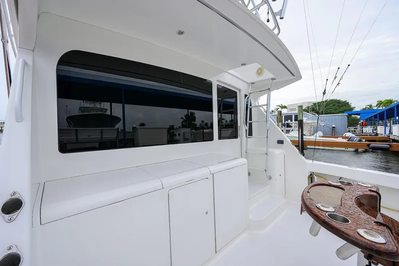 Slide: The Image of 2004 Viking 48 Convertible yacht deck with fishing rod holders and ladder. - 67