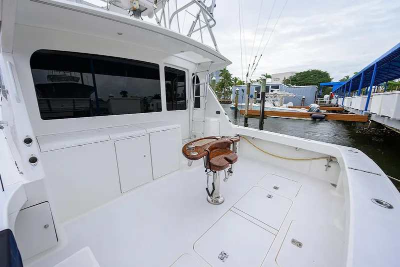 Slide: The Image of 2004 Viking 48 Convertible yacht with spacious deck and fishing chair at marina. - 68