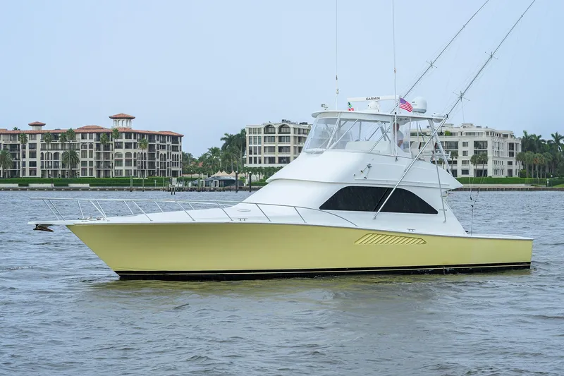 Slide: The Image of 2004 Viking 48 Convertible yacht on water with luxury buildings in background. - 7