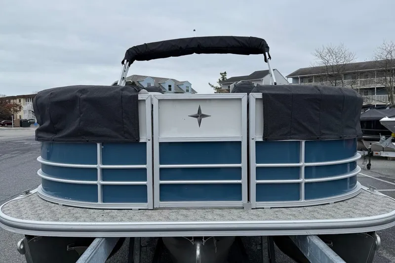 Slide: The Image of 2025 Berkshire 24RFX LE 2.75 pontoon boat with blue and silver exterior, docked. - 13