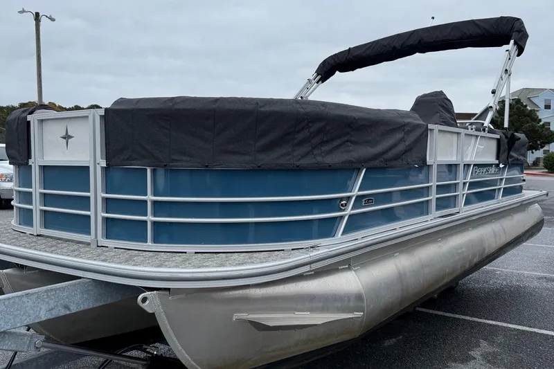 Slide: The Image of 2025 Berkshire 24RFX LE 2.75 pontoon boat with cover in parking lot. - 14