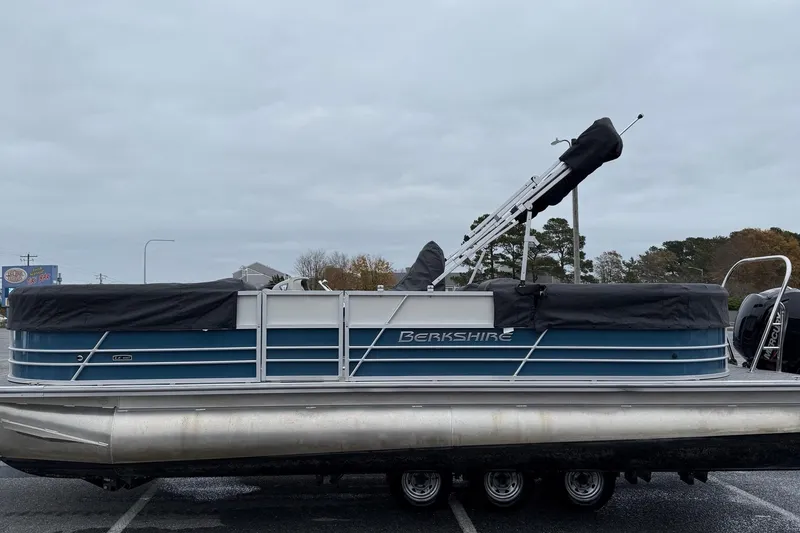 Slide: The Image of 2025 Berkshire 24RFX LE 2.75 pontoon boat with blue and silver design. - 15