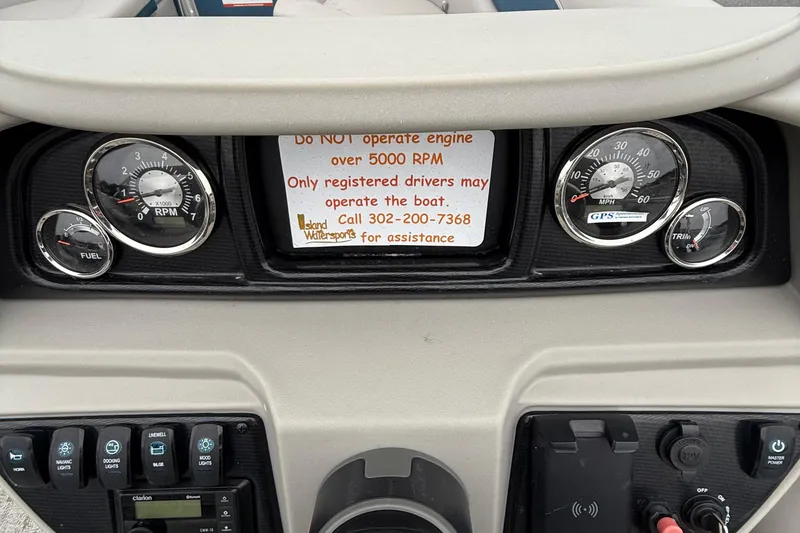 Slide: The Image of Dashboard of a 2025 Berkshire 24RFX LE 2.75 boat with gauges and warning sign. - 23
