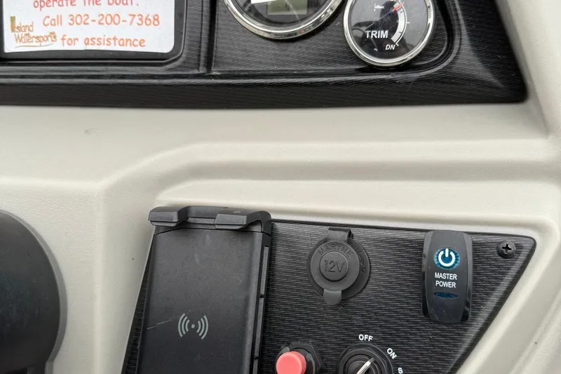 Slide: The Image of Control panel of 2025 Berkshire 24RFX LE 2.75 boat with power and trim gauges. - 25