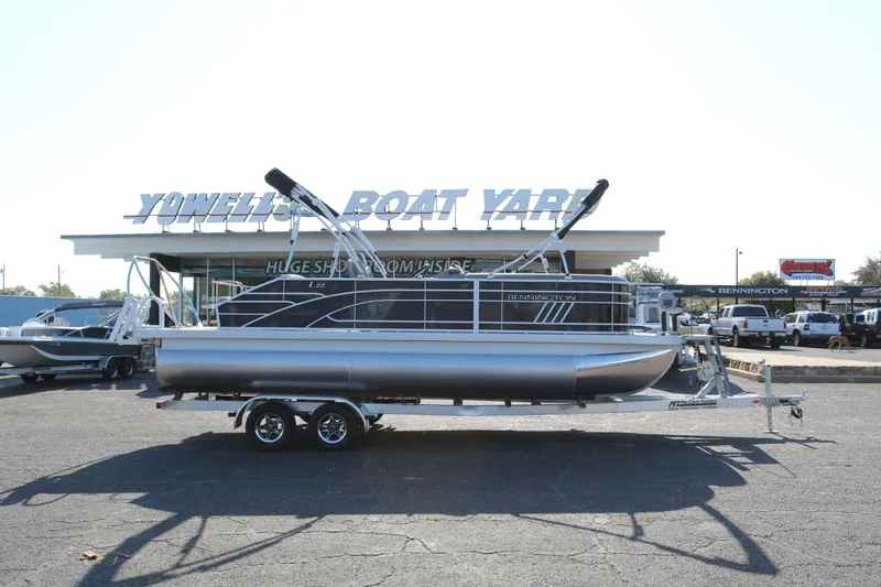 The Image of 2025 Bennington 22 LSWING BACK pontoon boat on trailer outside showroom. - 0