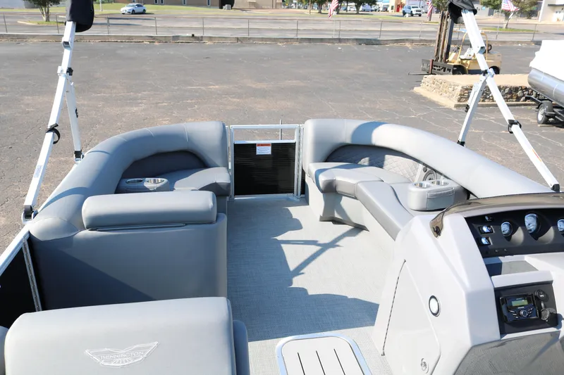 Slide: The Image of 2025 Bennington 22 LSWING BACK pontoon boat interior with gray seating and helm. - 16