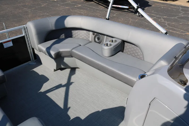 Slide: The Image of 2025 Bennington 22 LSWING BACK boat interior with gray seating and cup holders. - 18