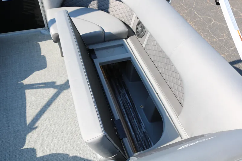 Slide: The Image of Bennington 22 LSWING BACK 2025 boat interior with open storage compartment. - 19
