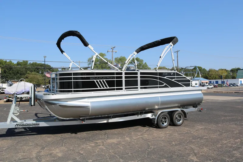 Slide: The Image of 2025 Bennington 22 LSWING BACK pontoon boat on trailer in parking lot. - 4