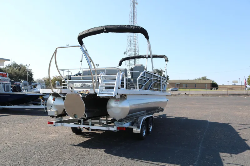 Slide: The Image of 2025 Bennington 22 LSWING BACK pontoon boat on trailer in parking lot. - 7