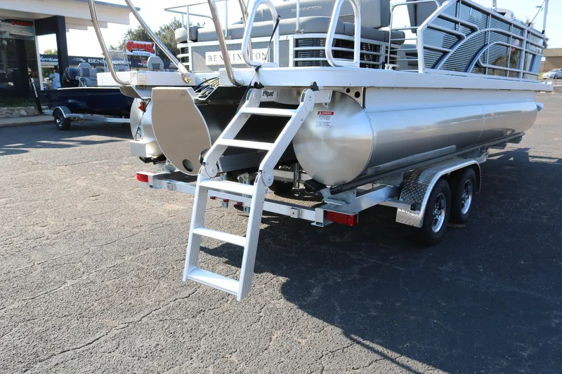 Slide: The Image of 2025 Bennington 22 LSWING BACK pontoon boat with rear ladder and trailer. - 9