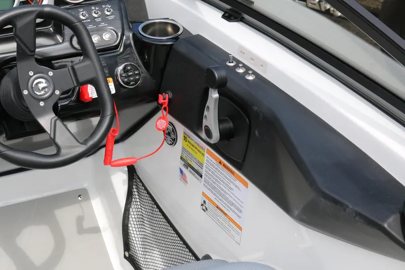 Slide: The Image of Control panel of 2026 Scarab 215 SE boat with steering wheel and throttle lever. - 11