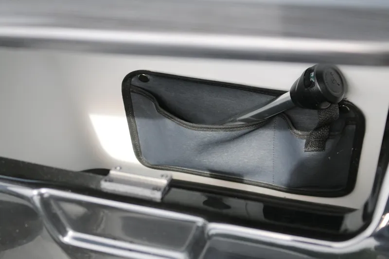 Slide: The Image of Interior storage compartment of 2026 Scarab 215 SE boat. - 13