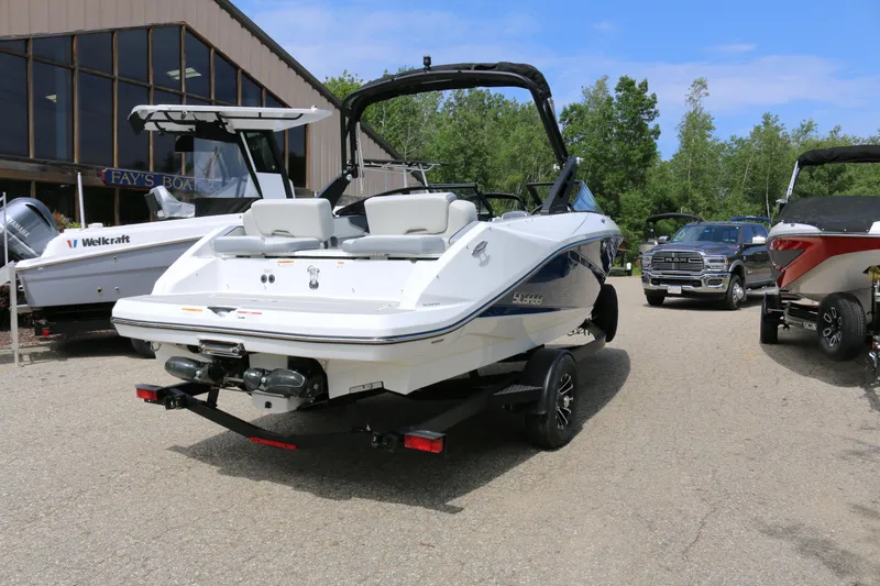 Slide: The Image of 2026 Scarab 215 SE boat on trailer in outdoor dealership lot. - 2