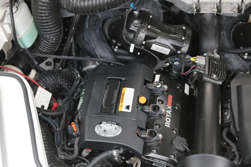 Slide: The Image of Engine compartment of 2026 Scarab 215 SE, featuring a Rotax engine with visible components and wiring. - 20