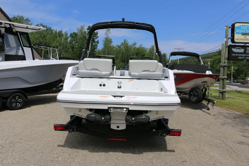 Slide: The Image of 2026 Scarab 215 SE boat, rear view, parked outdoors on a sunny day. - 3