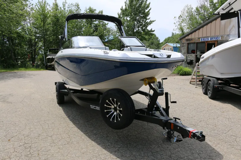 Slide: The Image of 2026 Scarab 215 SE boat on trailer, parked outdoors near sales office. - 4