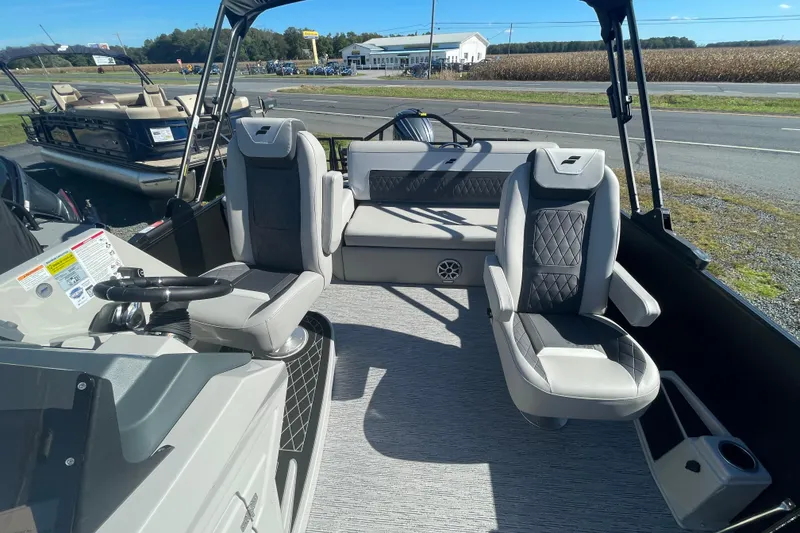 Slide: The Image of 2026 Starcraft SLS 3 Q DH boat interior with modern seating and steering wheel. - 13