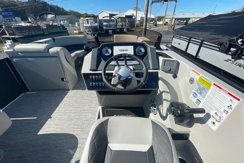 Slide: The Image of 2026 Starcraft SLS 3 Q DH boat with cushioned seating and cup holders. - 4