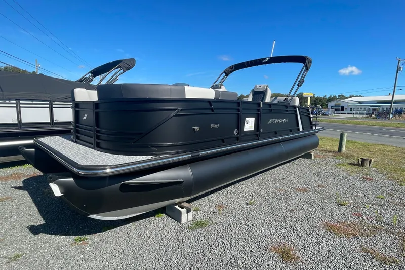 Slide: The Image of 2026 Starcraft SLS 3 Q DH pontoon boat with sleek black design on gravel lot. - 9