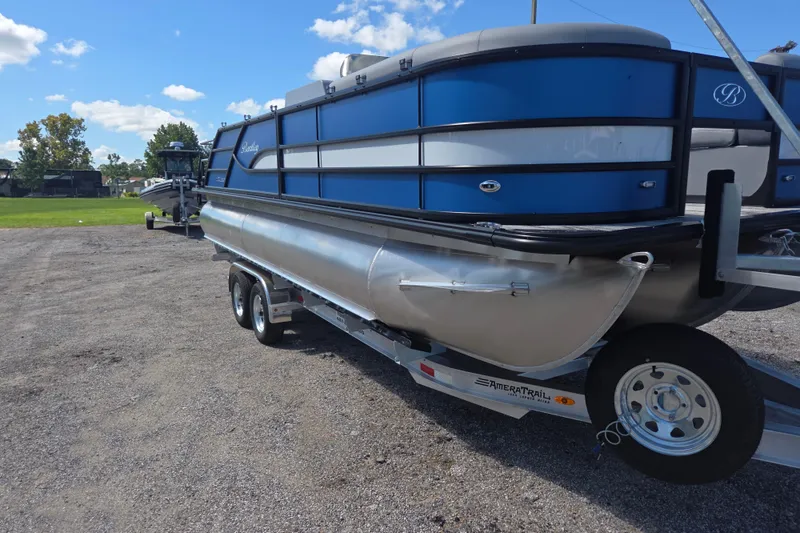 The Image of 2026 Bentley Pontoons 223 Swingback on trailer, blue and silver design, parked outdoors. - 1