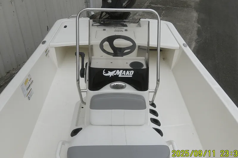 Slide: The Image of 2025 Mako Pro Skiff 17 CC boat interior with steering console and seating. - 10