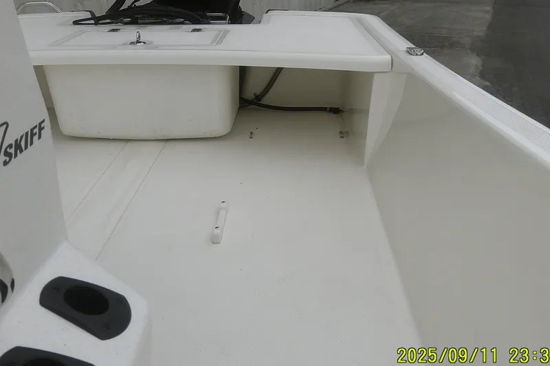 Slide: The Image of 2025 Mako Pro Skiff 17 CC boat interior, featuring spacious deck and storage compartments. - 15