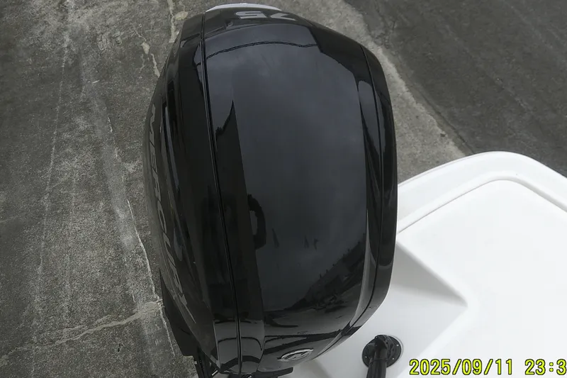 Slide: The Image of Black outboard motor on a 2025 Mako Pro Skiff 17 CC boat. - 19