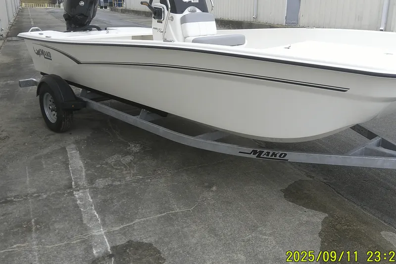 Slide: The Image of 2025 Mako Pro Skiff 17 CC boat on trailer, parked outdoors. - 26