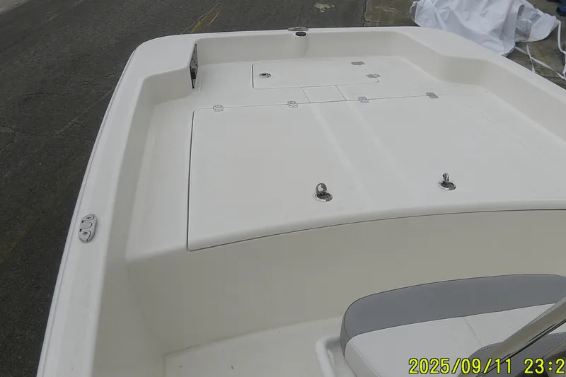Slide: The Image of 2025 Mako Pro Skiff 17 CC boat deck, featuring storage compartments and seating. - 3