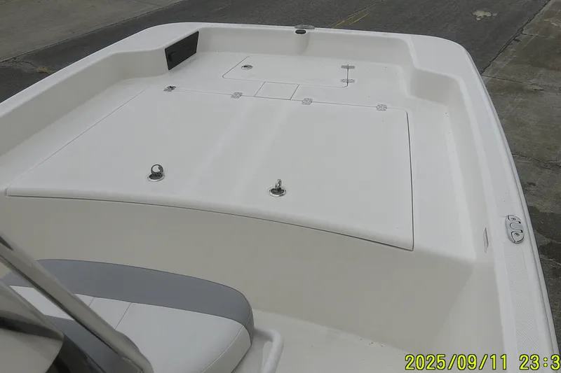 Slide: The Image of 2025 Mako Pro Skiff 17 CC boat deck with storage compartments and seating. - 4