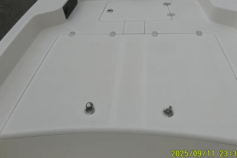 Slide: The Image of 2025 Mako Pro Skiff 17 CC deck with storage compartments and latches. - 7