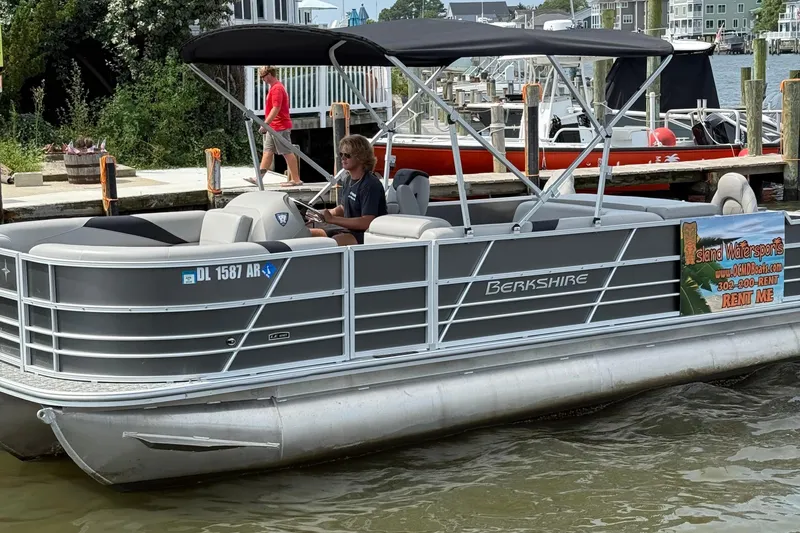 The Image of 2025 Berkshire 24RFC LE 2.75 pontoon boat parked at a marina. - 1