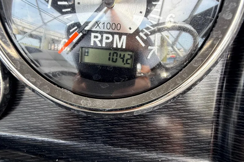 Slide: The Image of 2025 Berkshire 24RFC LE 2.75 pontoon boat with spacious seating and canopy in a parking lot. - 11