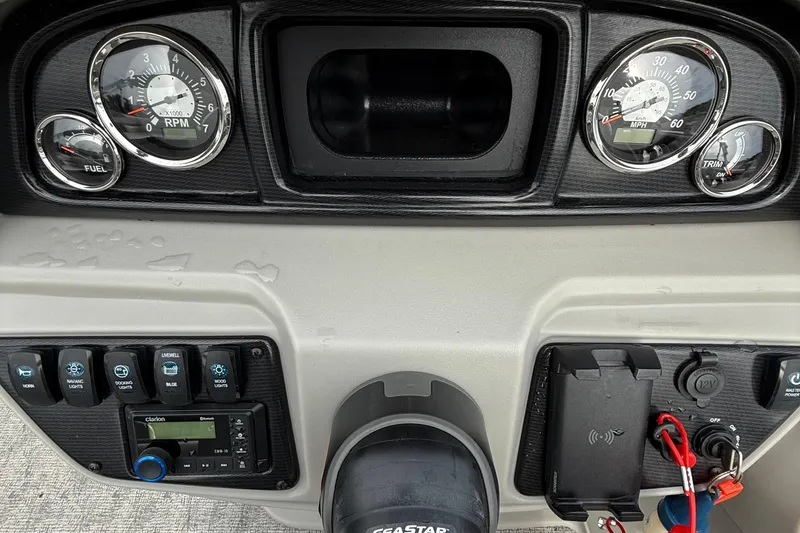 Slide: The Image of 2025 Berkshire 24RFC LE 2.75 boat interior with storage and cup holders. - 13