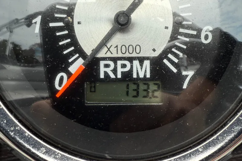 Slide: The Image of 2025 Berkshire 24RFC LE 2.75 boat helm with steering wheel and captain's chair. - 14