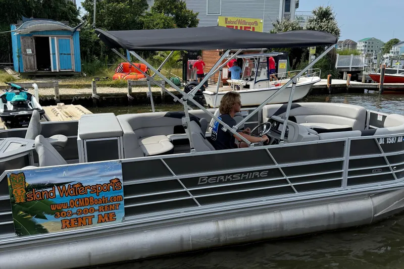 Slide: The Image of 2025 Berkshire 24RFC LE 2.75 pontoon boat on trailer, parked outdoors. - 4