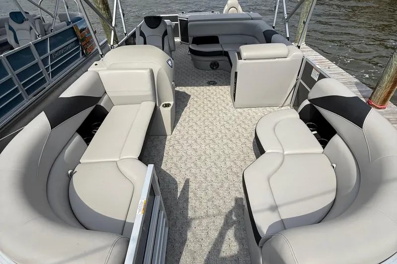 Slide: The Image of 2025 Berkshire 24RFC LE 2.75 pontoon boat with outboard motor in parking lot. - 6