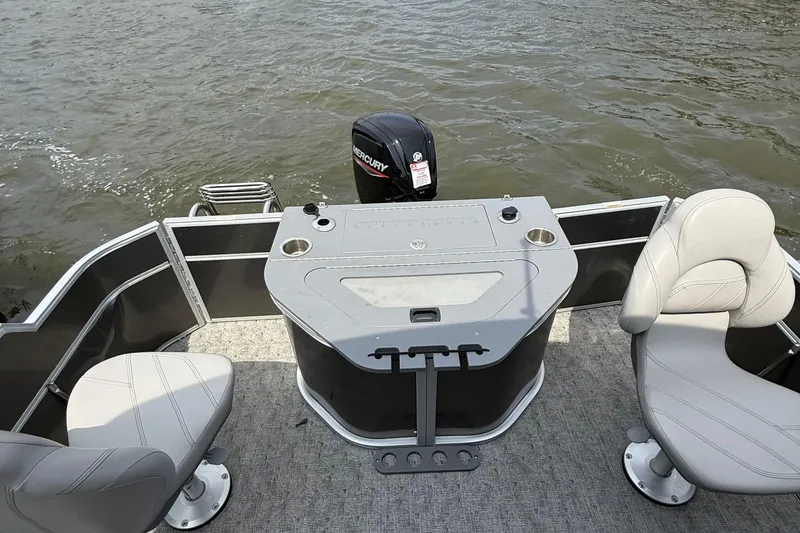 Slide: The Image of 2025 Berkshire 24RFC LE 2.75 pontoon boat with Mercury outboard engine in parking lot. - 8