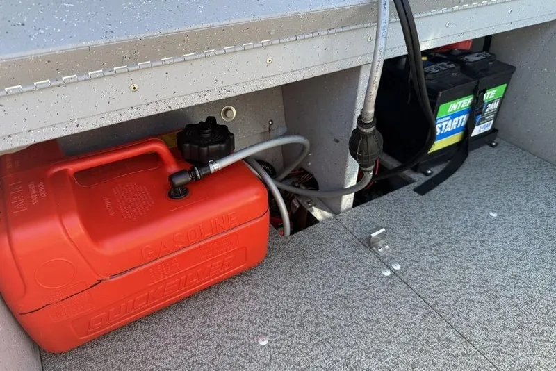 Slide: The Image of 2023 Lund 1400 Fury SS boat storage with gasoline tank and battery setup. - 10