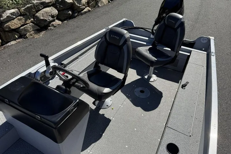 Slide: The Image of 2023 Lund 1400 Fury SS boat interior with two seats and steering console. - 11