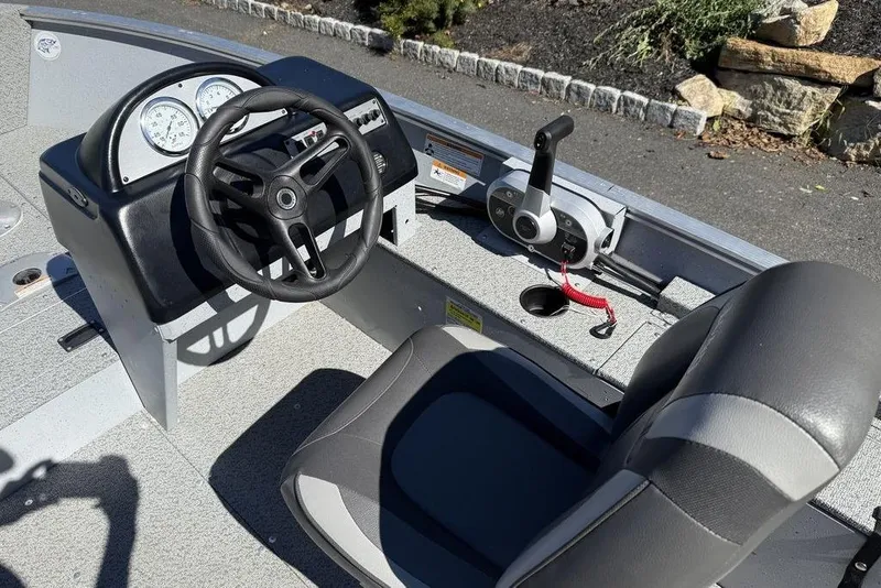 Slide: The Image of 2023 Lund 1400 Fury SS boat interior with steering wheel and control panel. - 5