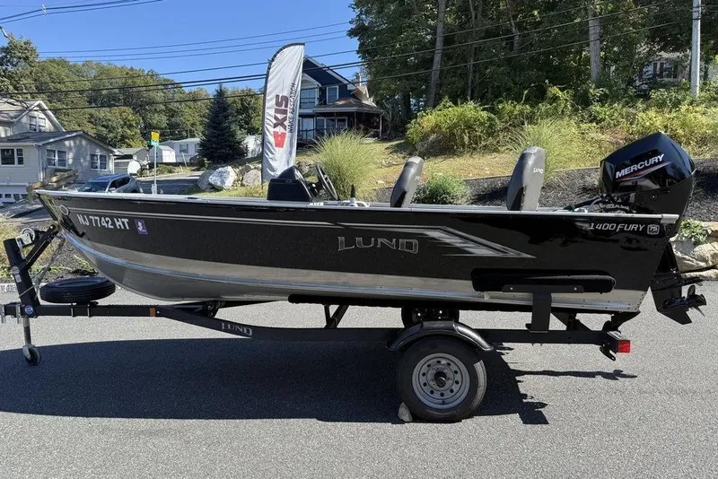 Slide: The Image of 2023 Lund 1400 Fury SS fishing boat on trailer, parked outdoors. - 6