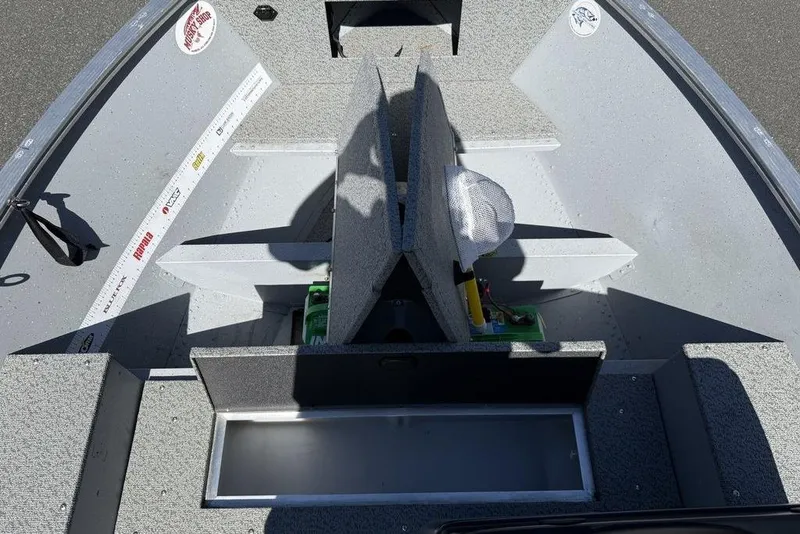 Slide: The Image of 2023 Lund 1400 Fury SS boat interior with storage compartments and seating. - 7