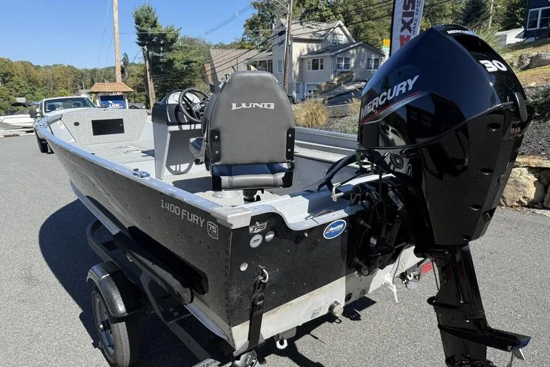 Slide: The Image of 2023 Lund 1400 Fury SS boat with Mercury engine on a trailer. - 9